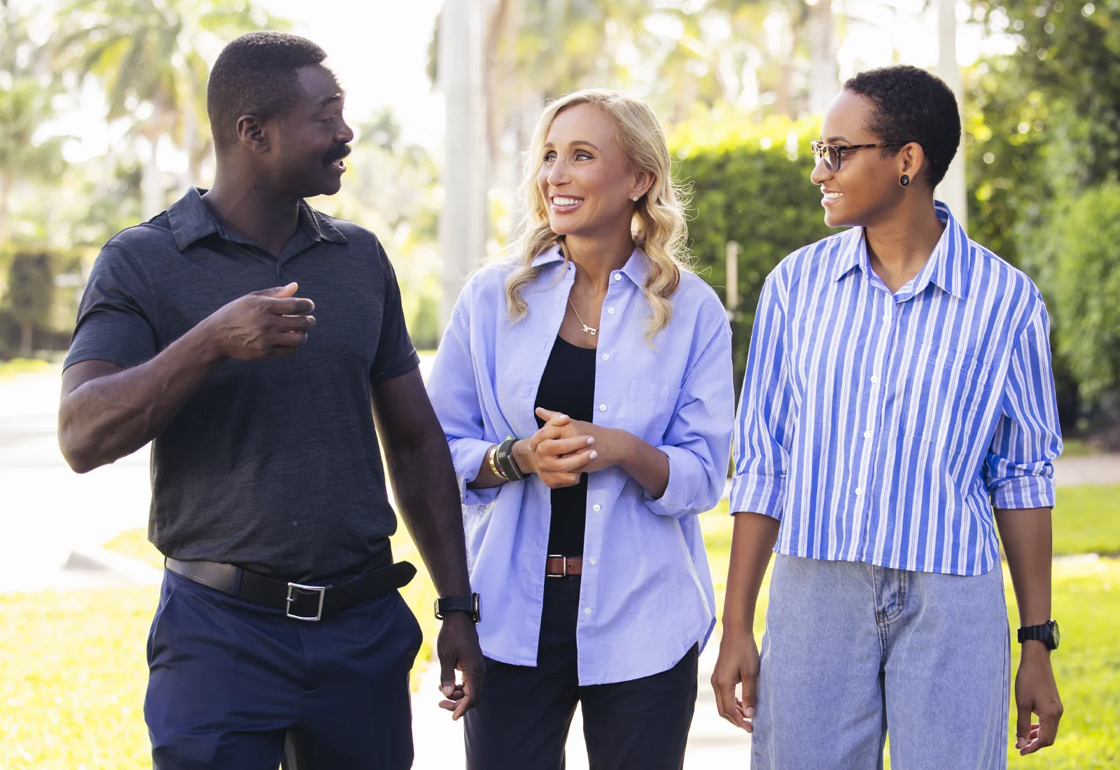 Lauren Book walking and talking with two constituents in the community.